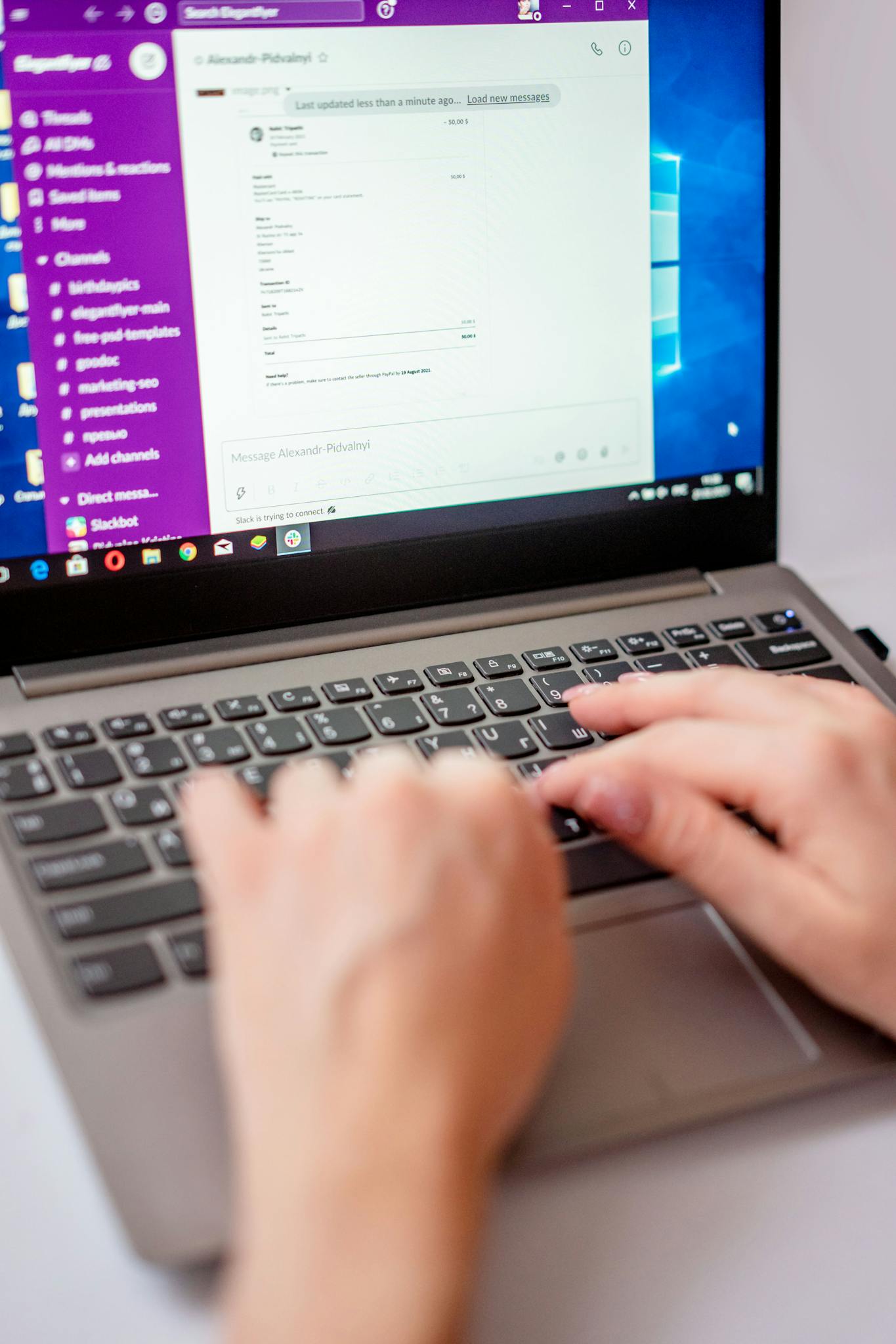 Close-up of hands typing on a laptop keyboard, ideal for tech and work scenes.